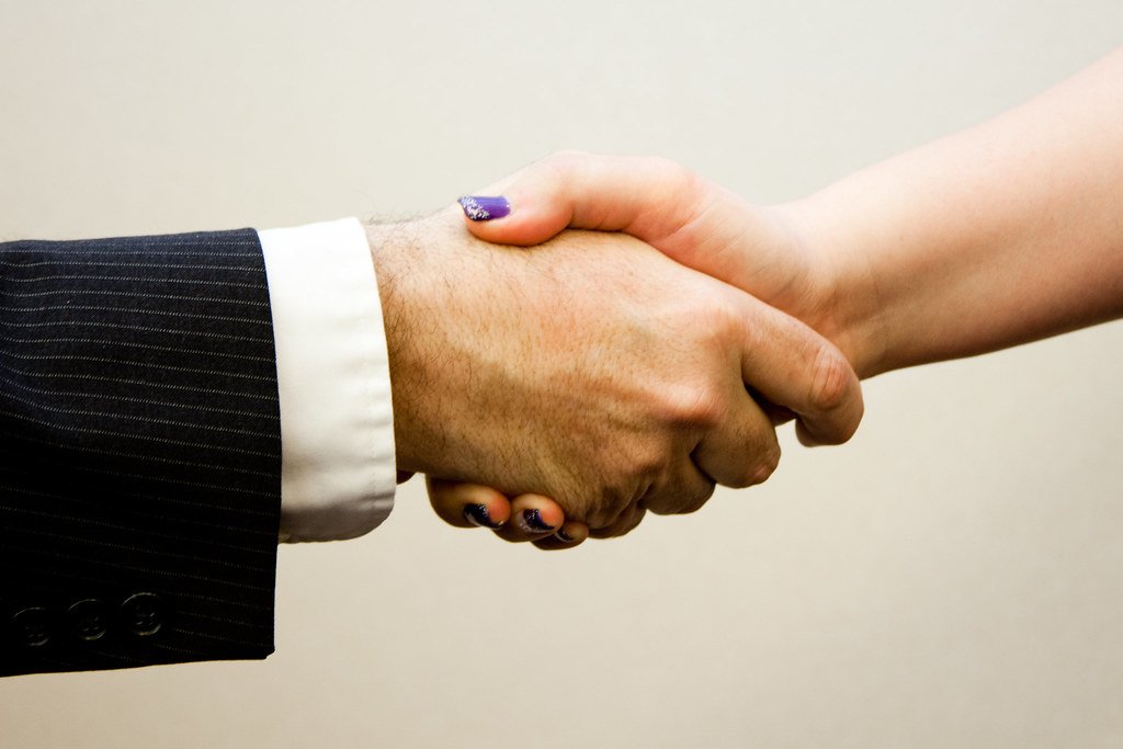 Cross-Border Contributions, CSR and Data Responsibility - Handshake man - women